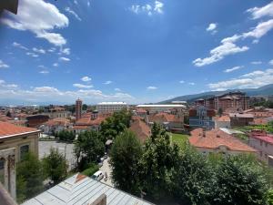 a view of a town with a train in the distance at Family Apartment in City Centre in Bitola