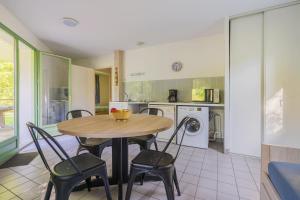 a kitchen with a table and chairs in a room at Gîtes De La Barbotine in Le Fuilet