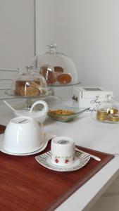 un mostrador con platos y tazas en una mesa con pastas en Impero5 Guest House, en Acquaviva delle Fonti