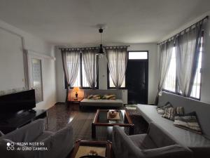 a living room with a couch and a table at Villa Konstantina in Perani