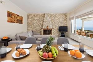 a living room with a table with fruit on it at Ionian Blue in Perama +17 photos