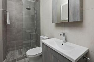 a bathroom with a toilet and a sink and a shower at Ionian Blue in Perama