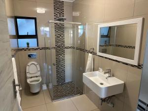 a bathroom with a toilet and a sink at St Ives beach access apartment in Margate