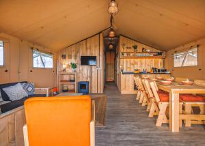 a dining room and kitchen in a tiny house at Folly Farm Holiday Park in Kilgetty