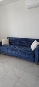 a blue couch with two pillows sitting in a room at Alanya-Avsallar 55m 1+1 in Avsallar