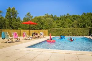 a group of people playing in a swimming pool at Gîtes De La Barbotine in Le Fuilet