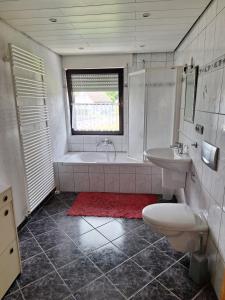 a bathroom with a tub and a toilet and a sink at Eifelliebe Monschau in Monschau +19 photos