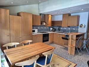 a kitchen with wooden cabinets and a wooden table at Eifelliebe Monschau in Monschau
