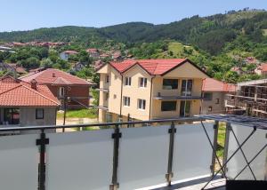 a view of a house under construction from a balcony at Cozy apartment with mountain view in Makedonska Kamenica