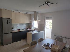 a kitchen and dining room with a table and a dining room at Cozy apartment with mountain view in Makedonska Kamenica