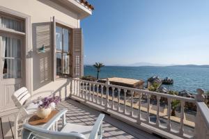 a balcony with chairs and a view of the water at Nars Ilica Hotel Beach Adults Only 12Plus in Cesme