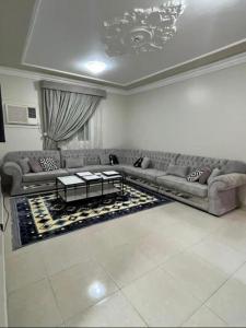 a living room with couches and a coffee table at شقق بدور أرضي in Al-Salam