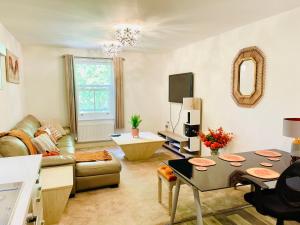 a living room with a couch and a table at Chattel Bedford in Bedford