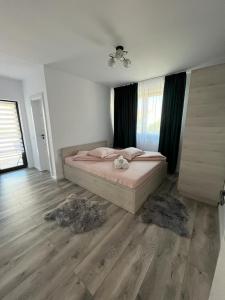 a bedroom with a bed and a wooden floor at Casa Lucia in Sibiu