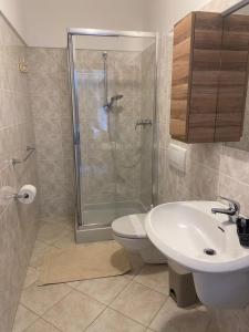 a bathroom with a shower and a toilet and a sink at Casa Camilla in Colico +12 photos