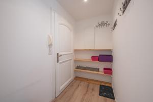 a hallway with white cabinets and a door at Résidence Le Cristal - Nant Blanc 2 - Happy Rentals in Chamonix-Mont-Blanc