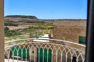 a view from a window of a building with a gate at Azure W B&B in San Lawrenz