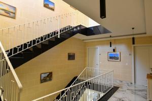 a spiral staircase in a building with a hallway at Azure W B&B in San Lawrenz