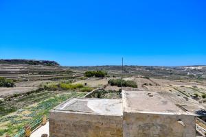 an aerial view of an old building in a field at Azure W B&B in San Lawrenz