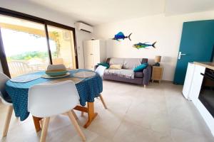 a living room with a table and a couch at Superbe, rénové, au calme, plage 200m, terrasse vue Mer! in Rayol-Canadel-sur-Mer