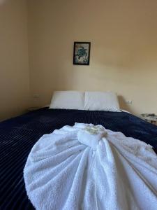 a bedroom with a bed with a dress on it at Recanto Lua Clara in Campos do Jordão