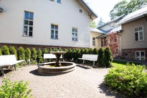 a courtyard with two benches and a fountain at LOSSI 21/23 in Tartu