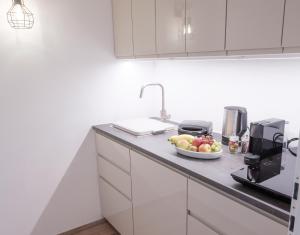 a kitchen with a bowl of fruit on a counter at Ferienwohnung im Naturpark Almenland in Fladnitz an der Teichalm