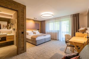 Postel nebo postele na pokoji v ubytování Hotel OTP Birkenhof