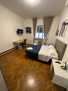 a hotel room with a bed and a desk at Civico 85 in Rome