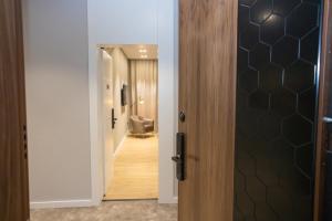 a hallway with a door leading into a room at Bee Hotel in Vlorë
