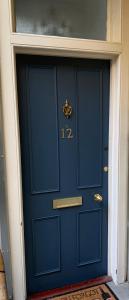 a blue door with the number on it at Glamours stylish Victorian apartment near city centre in Edinburgh