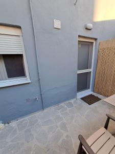 a blue building with a door and a patio at ANAFIS COZI in Athens