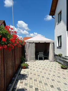 a tent with a table and a chair in a patio at Casa Lucia in Sibiu