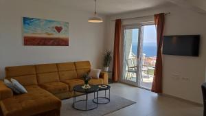 a living room with a couch and a view of the ocean at The Father's House in Bol