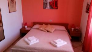 Postel nebo postele na pokoji v ubytování B&B Bella Calasetta