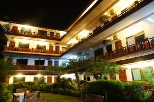 a hotel at night with chairs in the courtyard at Namkhong Riverside in Chiang Khong
