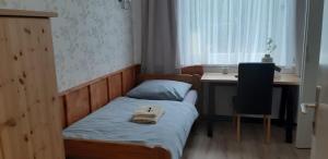 - une petite chambre avec un lit et un bureau dans l'établissement Pension Haus Sonneck, à Wildemann