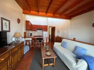 a living room with a couch and a table at Finca La Romera in La Orotava