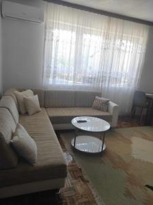 a living room with a couch and a table at Ajsha Guesthouse in Jajce