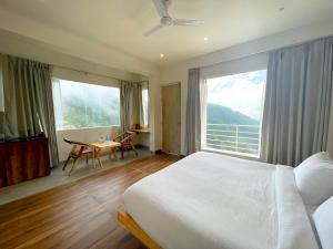 a bedroom with a bed and a large window at Onehouse Resort Lansdowne in Lansdowne