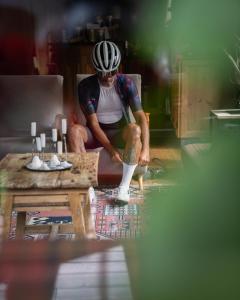 a man with a helmet on his knee and a table at La Genzianella Bormio in Bormio