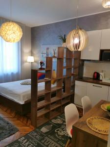 a bedroom with a large bed and a kitchen at Apartman Jovana 2 in Belgrade