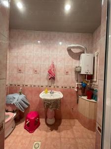 a bathroom with a sink and a toilet at Veyasum Guest House in Ganja