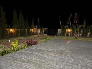 a garden at night with a brick walkway at Villa Nour in El Jadida