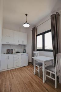 a kitchen with a table and two chairs and a table and a table at Vila Muka in Ksamil