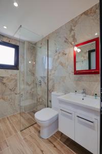 a bathroom with a toilet and a sink and a shower at Vila Muka in Ksamil