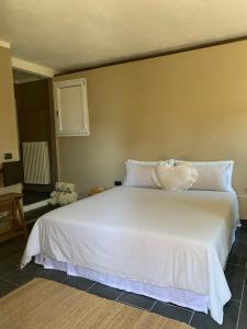 una camera da letto con un letto bianco e un cuscino sopra di Il Riccio appartamento a Cernobbio