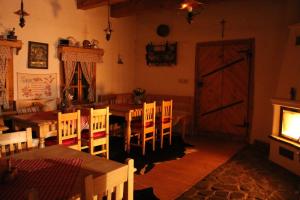 ein Esszimmer mit einem Tisch, Stühlen und einer Tür in der Unterkunft Drevenica in Oščadnica