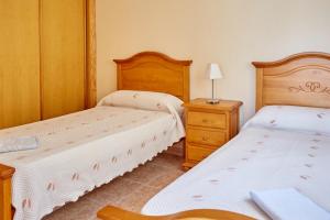 Postel nebo postele na pokoji v ubytování Apartamento Lorelay Familia