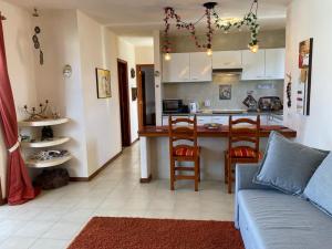 a living room with a couch and a kitchen at The White Dragos with Ocean view - AC - private pool in Tías